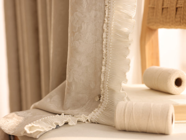 Ivory chenille blackout curtain with decorative pleated ruffle and pearl-like trim