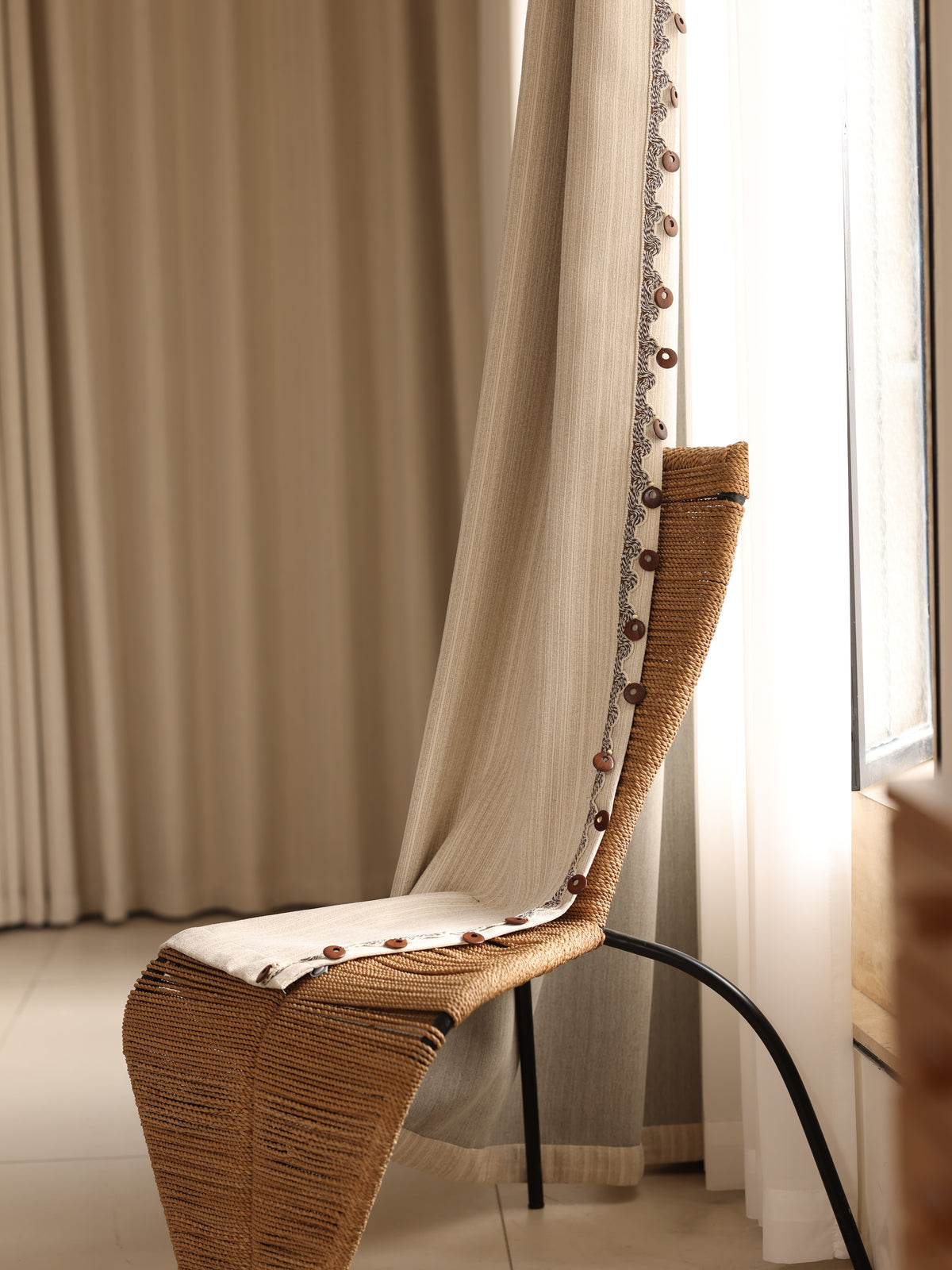 Round wooden buttons along the decorative jacquard curtain edge