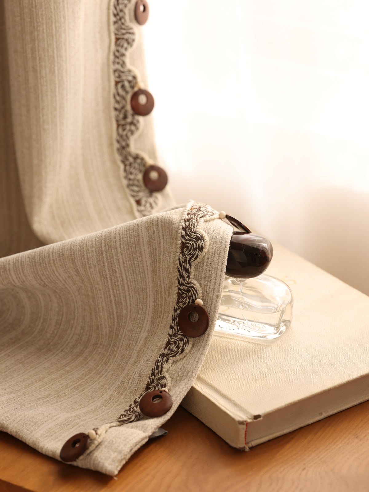 Warm beige jacquard curtain fabric shown in natural window light