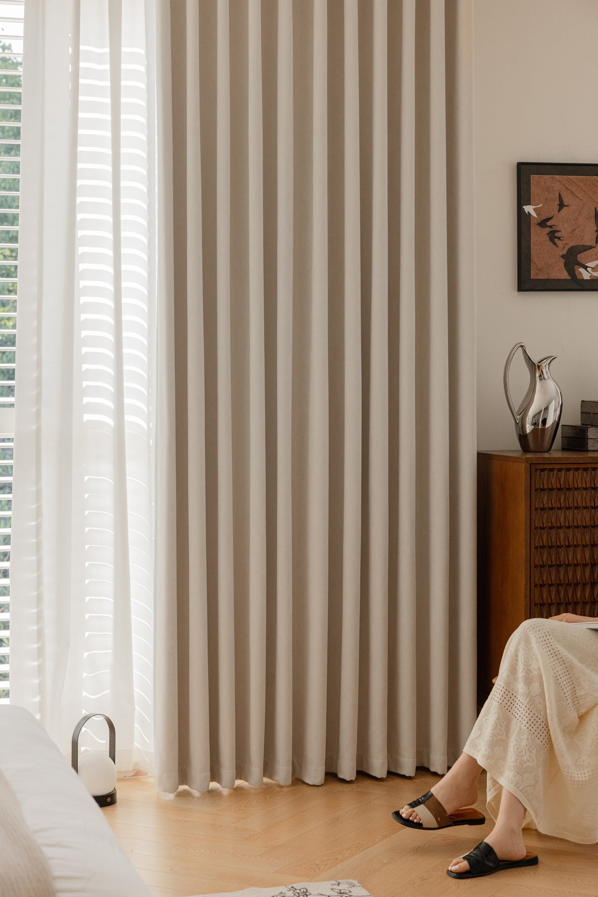 Heavy chenille blackout curtain hanging in deep structured pleats