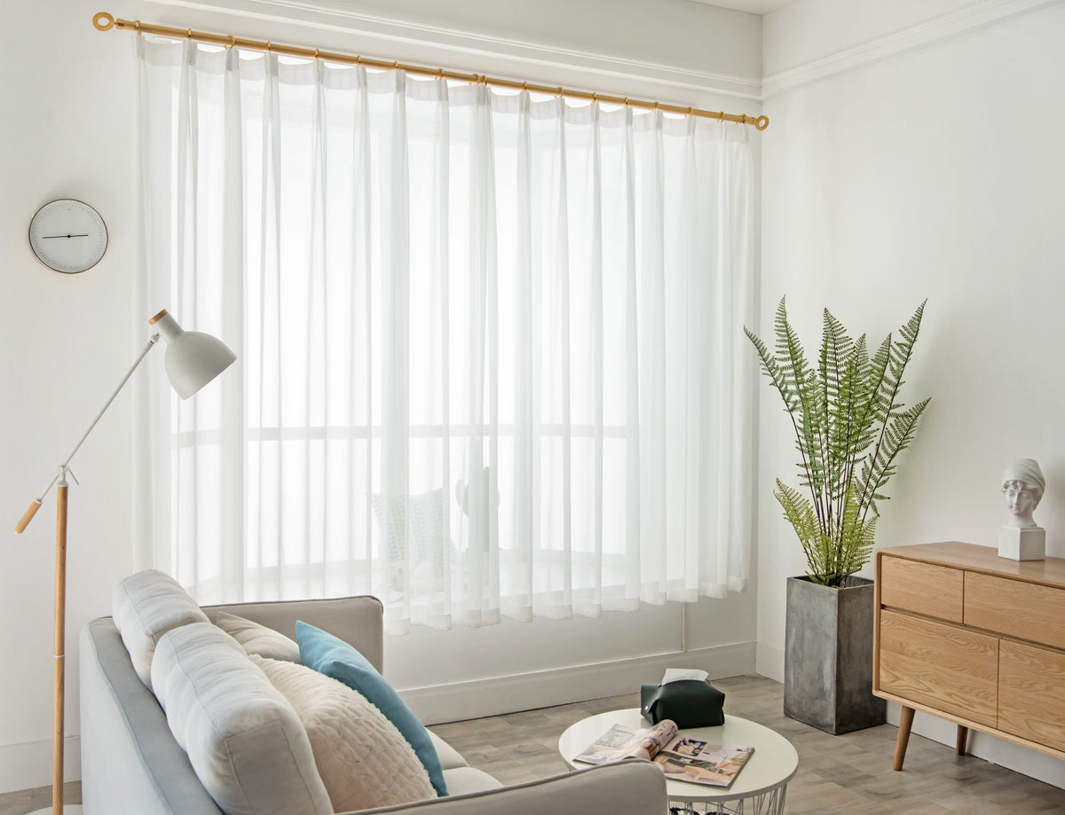 Custom white sheer curtains for a bright living room window