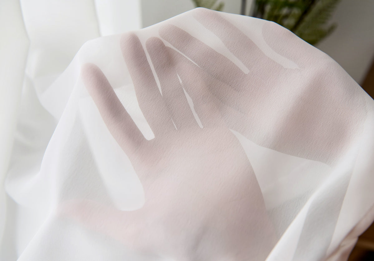 Close-up of high-density diamond mesh sheer fabric filtering natural light