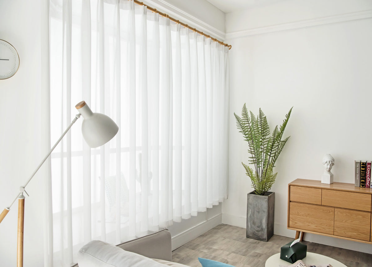 Side view of light-filtering white diamond mesh sheer curtains