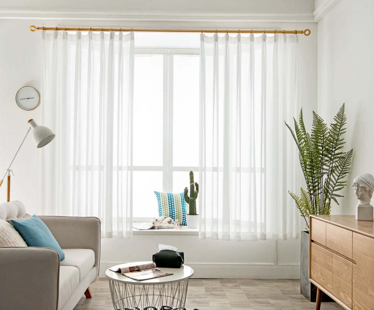 White diamond mesh sheer curtain softly filtering daylight in a modern living room