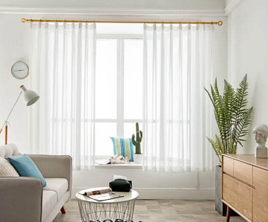White diamond mesh sheer curtain softly filtering daylight in a modern living room