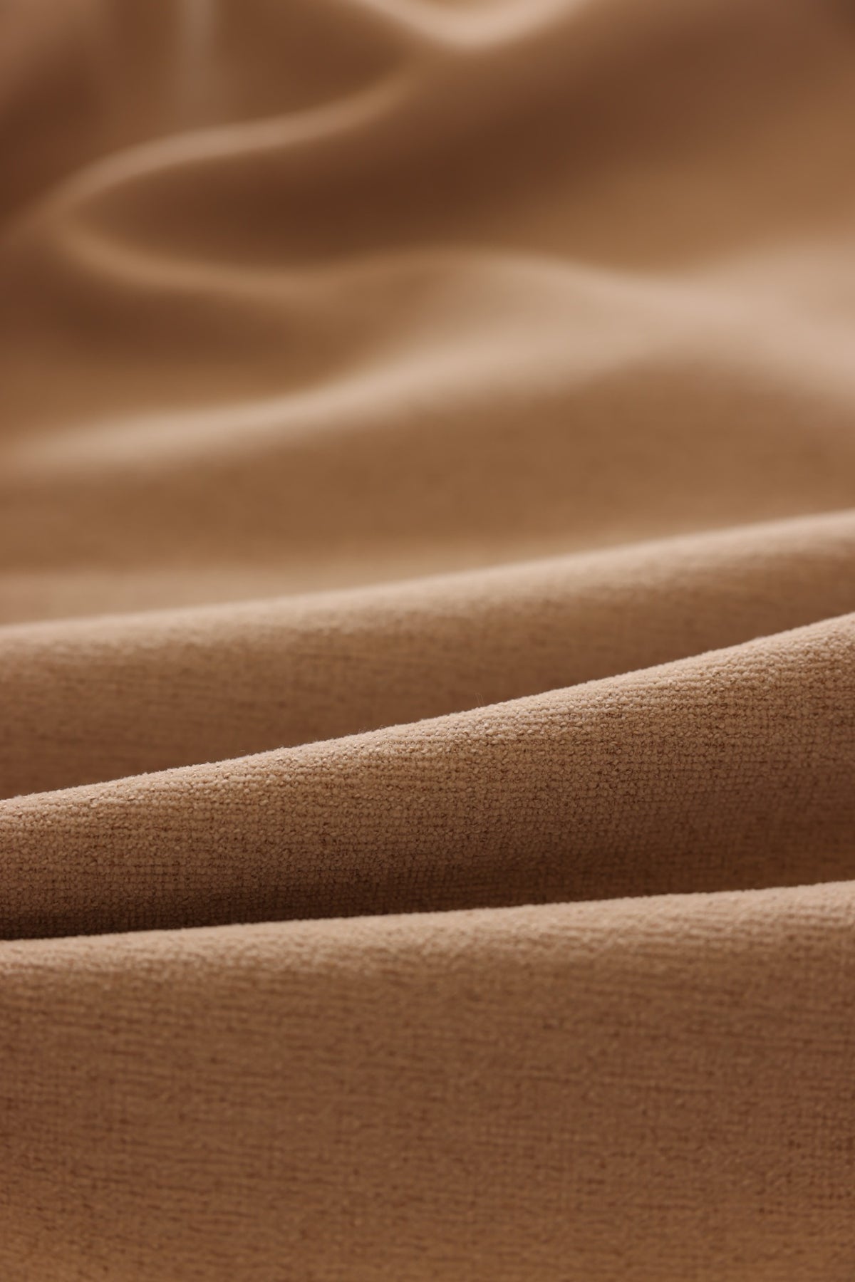 Warm beige chenille curtain falling in soft full-length folds