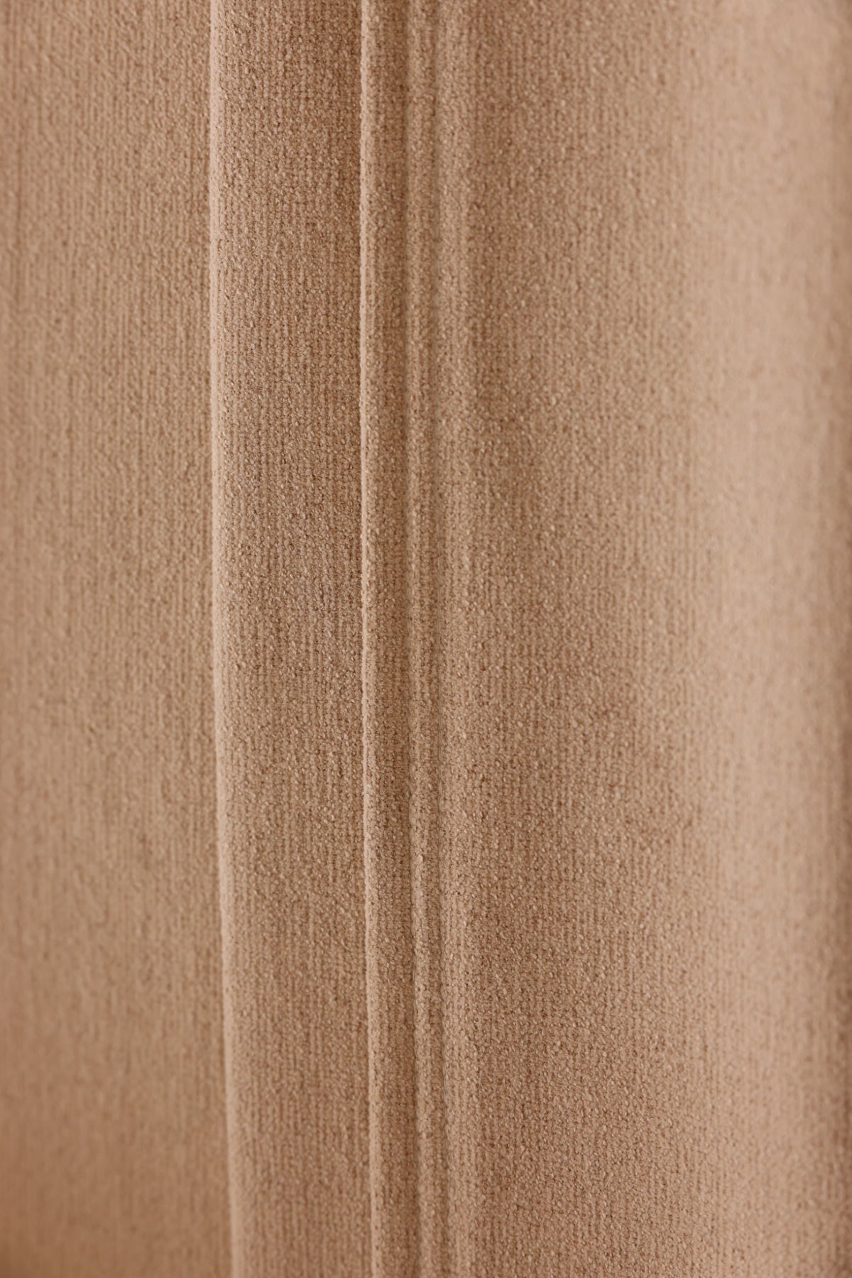 Neatly finished seam on a warm beige chenille blackout curtain